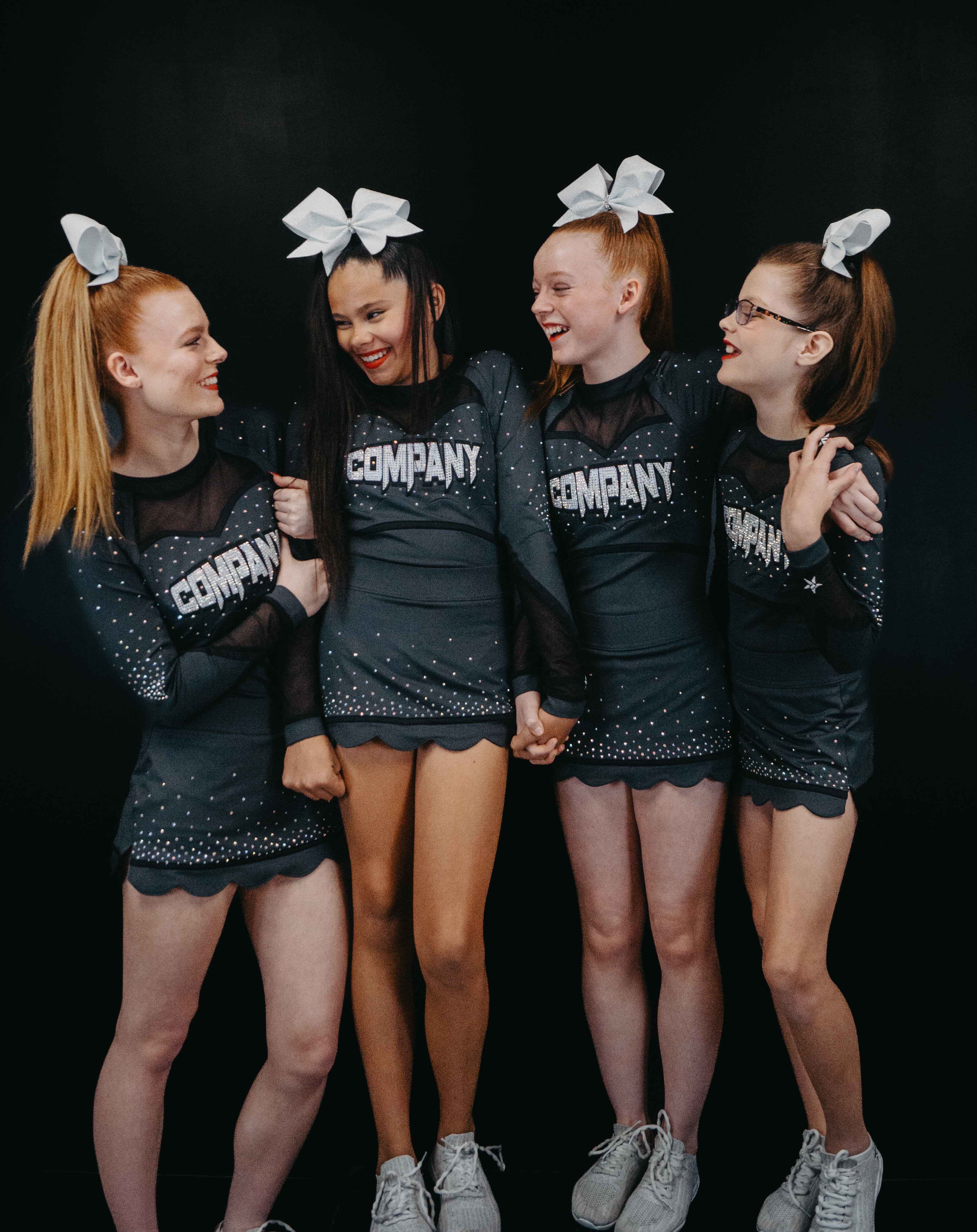 Four students in matching cheer uniforms